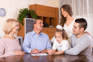 family discussing a will at the dining room table