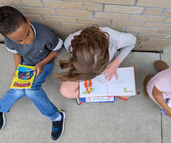 Children reading books from the PAKRAT library bus